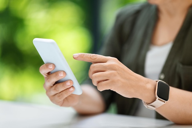 Woman hands holding using cell mobile smartphone cropped