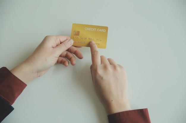 Woman hands holding and using cradit card for shopping online