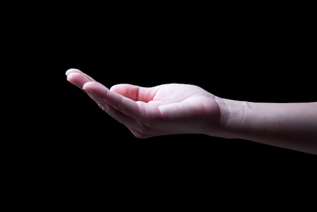 Woman hands palms up over black background