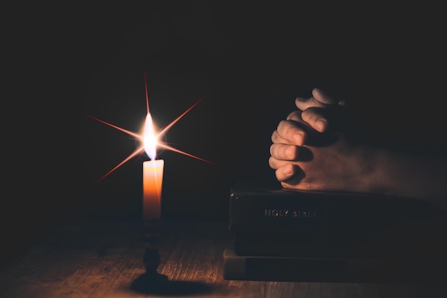 Woman hands praying on holy bible