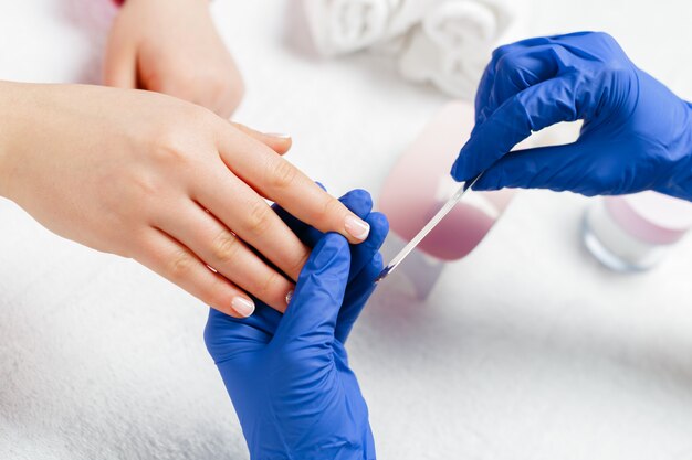 Woman hands receiving a manicure in beauty salon