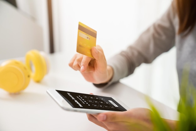 Woman hands using mobile banking on smartphone with holding credit card and enter password to login application