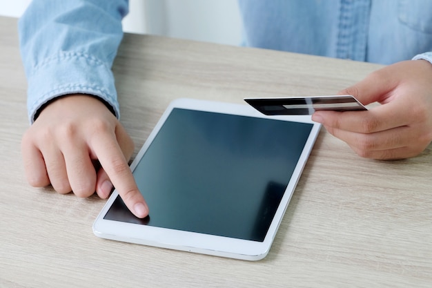 Woman hands using tablet and holding credit card, shopping online concept, business and technology