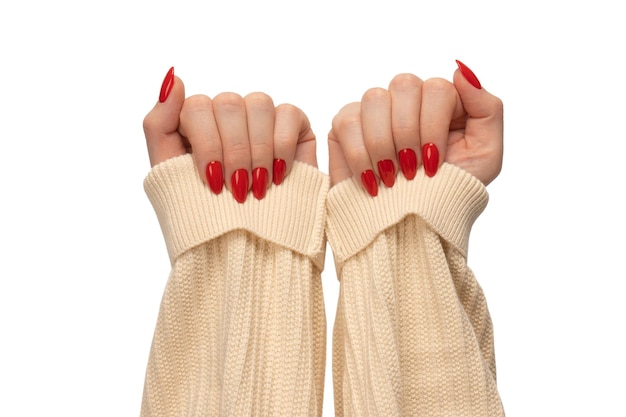 Woman hands with red nails isolated on a white background