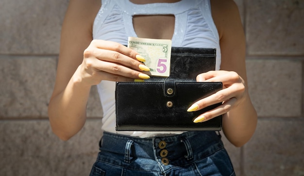 Woman hands with wallet and money