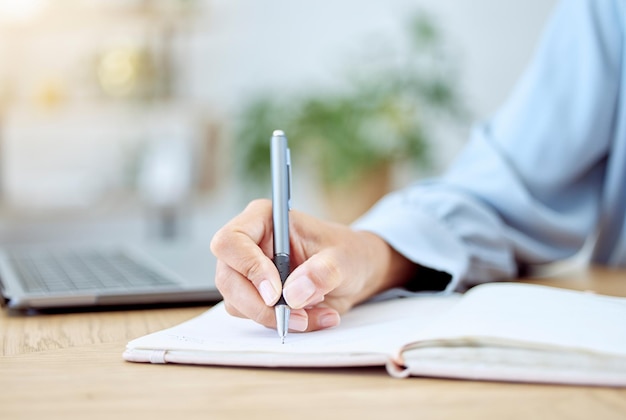 Woman hands writing notebook and planning ideas at receptionist desk in startup Closeup writer journalist and secretary of schedule agenda planner and strategy reminder budget notes and analysis