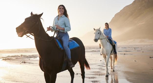 Woman happy and horse riding with face at beach for bond activity or self care on holiday Female friends or people on vacation by travel for relaxing health or love at shore mountains and sport