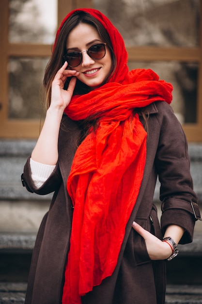 Woman happy in red scarf in winter outside