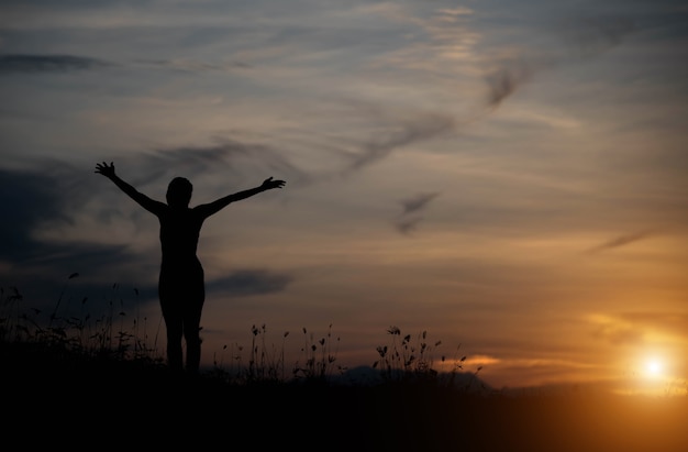 Woman happy at sunset.