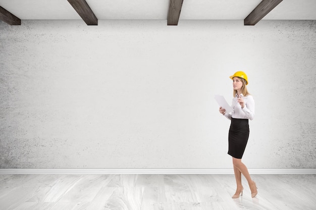 Woman in hardhat in empty room