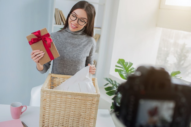 Woman has found a present in the basket with laundry