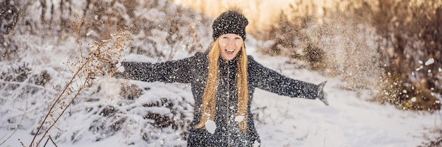 Woman has fun in winter throws snow banner long format