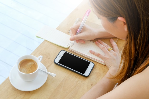 Woman has good time for work with mobile in coffee shop the nice place of work space