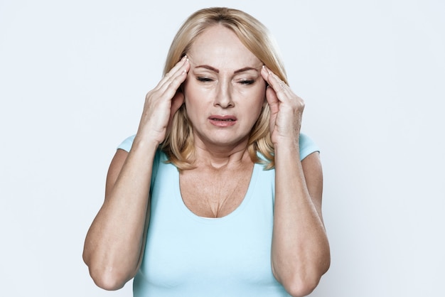 A woman has a headache in clinic.