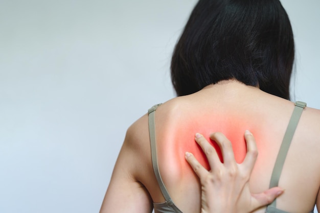 A woman has itching on her back because she is allergic to something