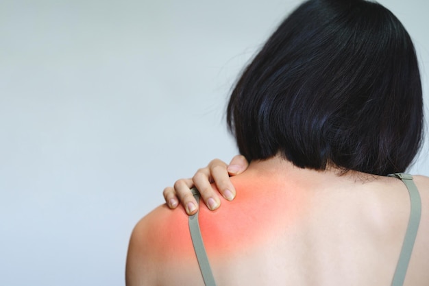 A woman has pain in her shoulder blades because she sits at work for too long