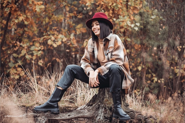 Woman in a hat and coat in the woods