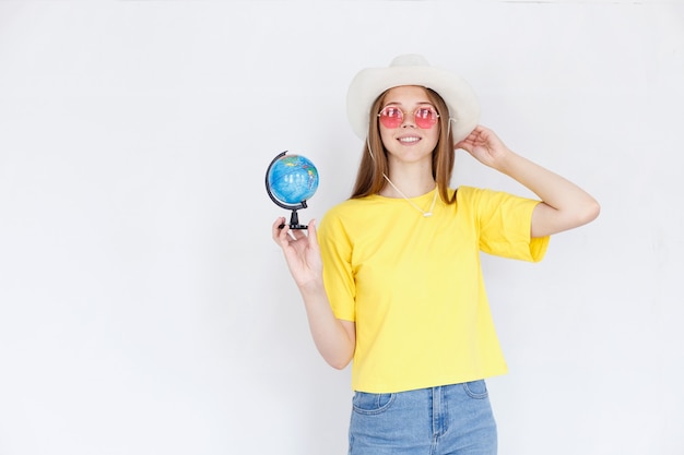 Woman in a hat with a globe on a white background