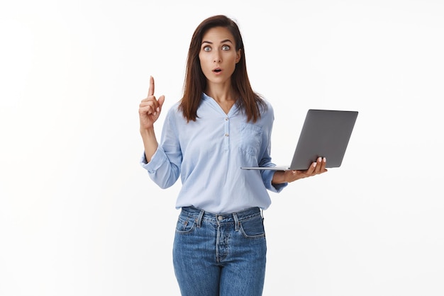 Woman have good business idea Excited creative brunette businesswoman raise finger eureka gesture hold laptop stare ambushed open mouth share awesome plan suggest solution white background