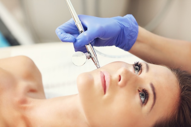 woman having facial treatment in beauty salon