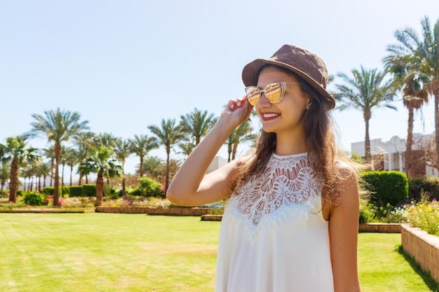 Woman having fun and enjoying relaxing summer tropical vacation at the park