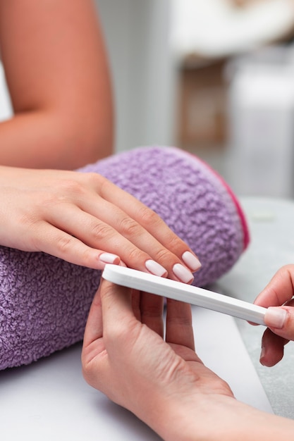 Woman having her manicure done at the salon