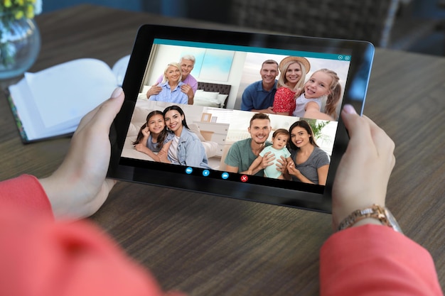 Woman having online meeting with family members via videocall application indoors closeup