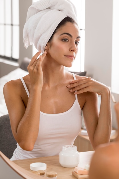 Woman having a relaxing day and using face cream