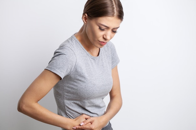 Woman having a stomachache or menstruation pain Health care and medical concept