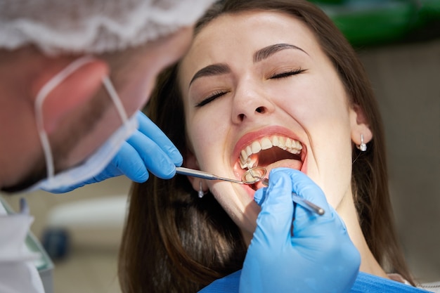 Woman having teeth check up at dentist office