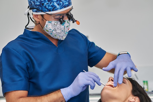 Woman having teeth examined at dentists.