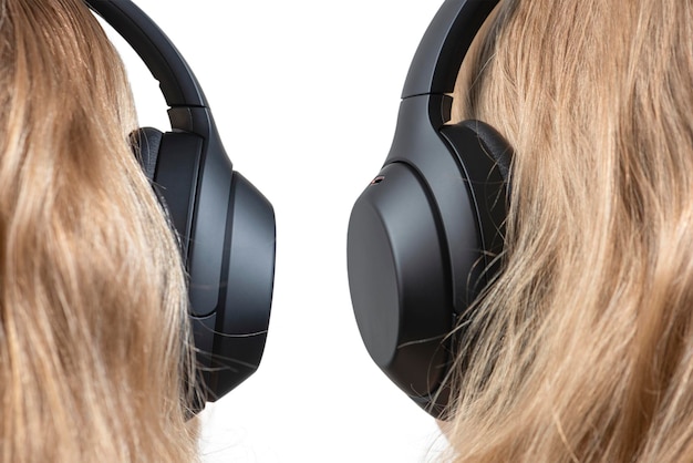 Woman in headphones isolated on white Black headphones on a woman's head Head of a fairhaired woman in headphones rear view closeup