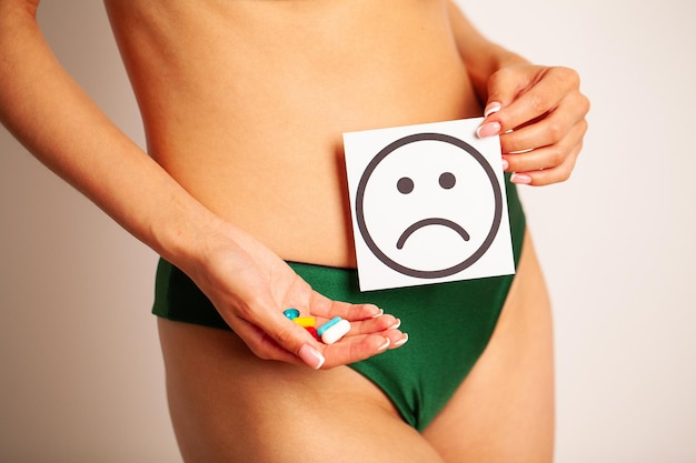 Woman health female body holding white card sad smile near stomach healthy