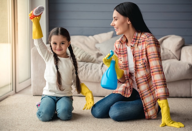 Woman and her little daughter in protective gloves