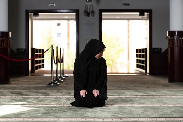 Woman in Hijab Sitting in Mosque and Praying