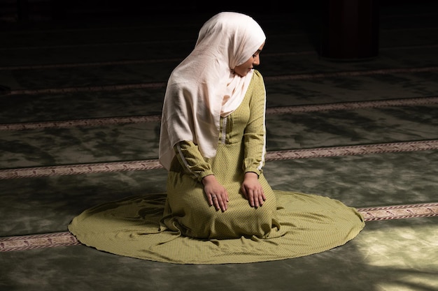 Woman in Hijab Sitting in Mosque and Praying