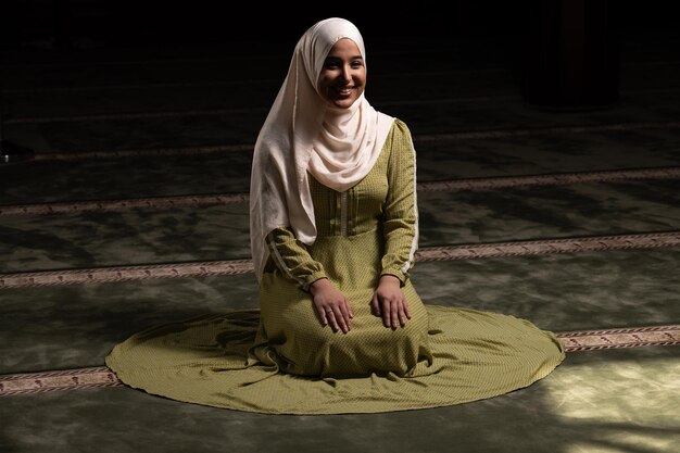 Woman in Hijab Sitting in Mosque and Praying