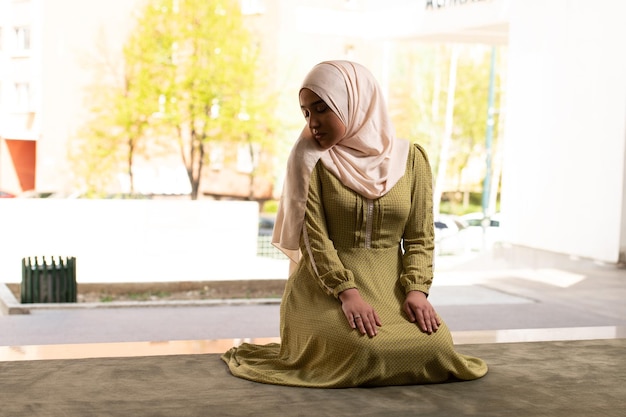 Woman in Hijab Sitting in Mosque and Praying