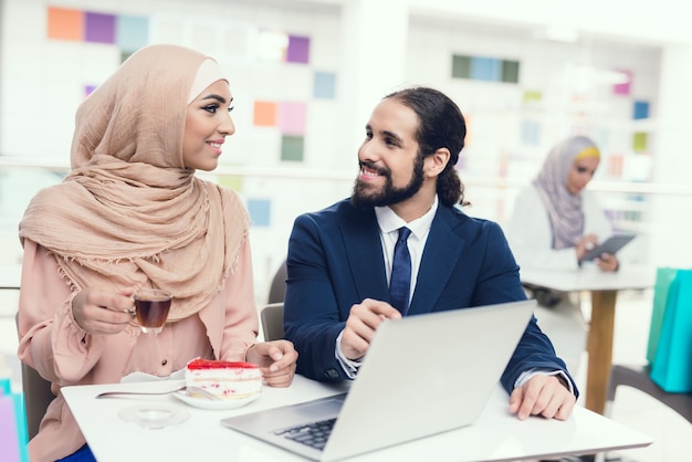 Woman in Hijab with Suit Man in Mall.