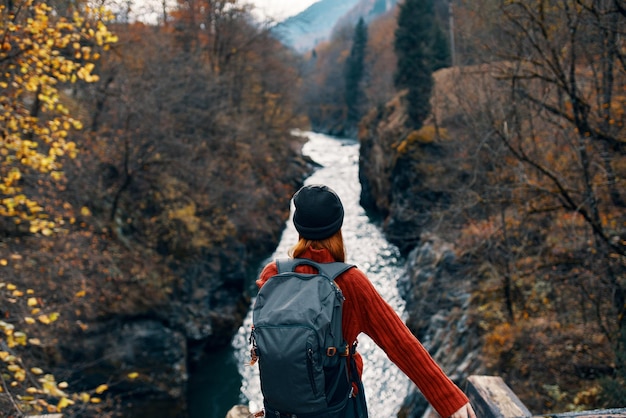 Woman hiker backpack mountains river fresh air