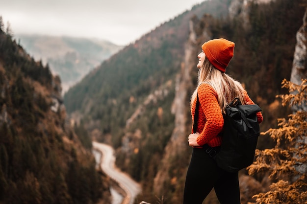 Woman hiker sits and enjoys valley view from viewpoint Hiker reached top of the mountain and relaxes Slovakia mala fatra Adventure and travel in the mountains region