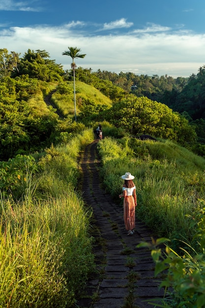 Woman hiking at the Bukit Campuhan on a sunny day in Bali Indonesia