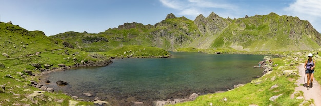 Woman hiking near a mountain lake