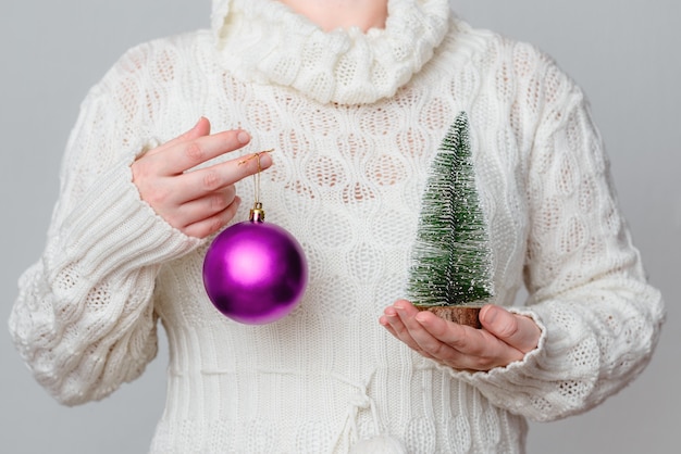 Woman hold Christmas tree and an ornament Christmas or New Year holiday background