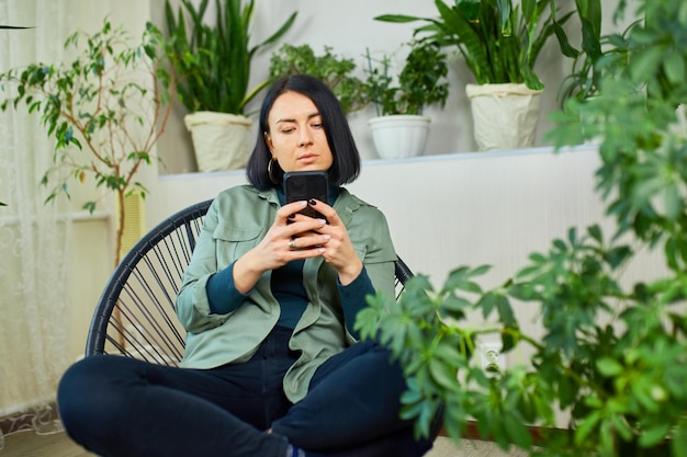 Woman hold mobile phone and surfing internet type message