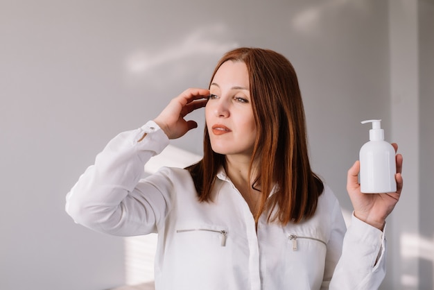 Woman holding antibacterial soap sanitizer. Coronavirus concept