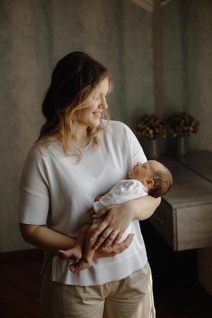 a woman holding a baby and a baby in her arms