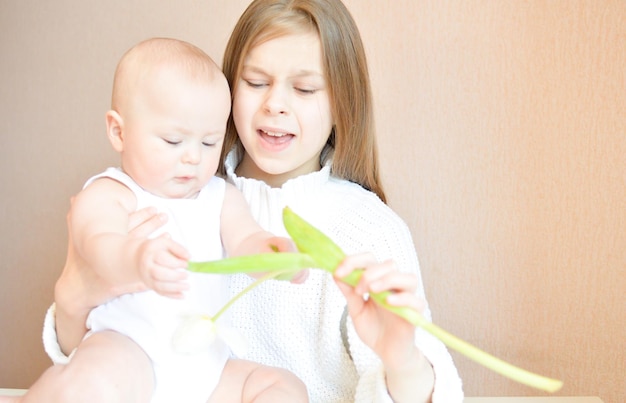 a woman holding a baby and a toy that says  baby