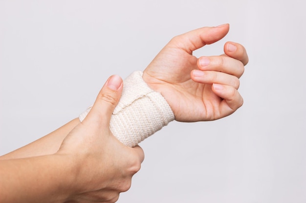 A woman holding a bandaged wrist in her hand Wrist injuries arm pain carpal tunnel syndrome