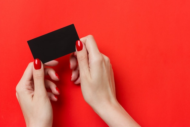 Woman holding black business card mockup